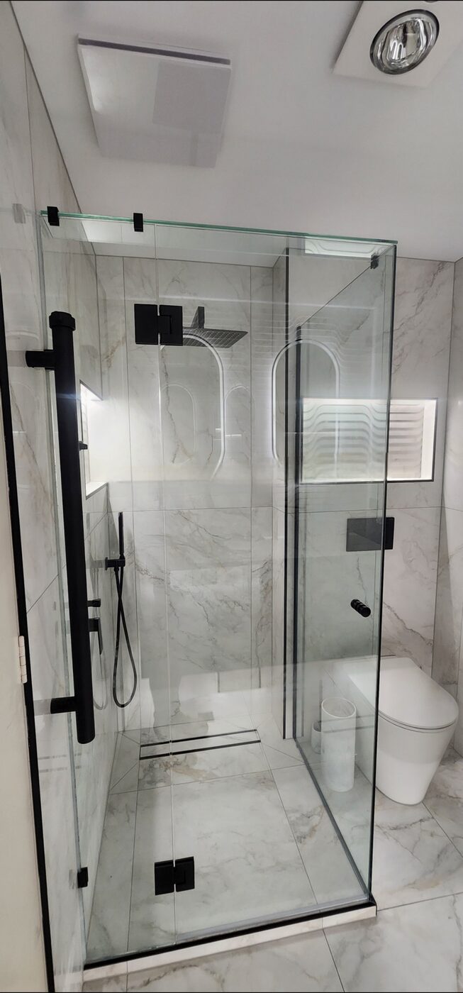 Frameless marble walk-in shower with black tapware, Albert Park