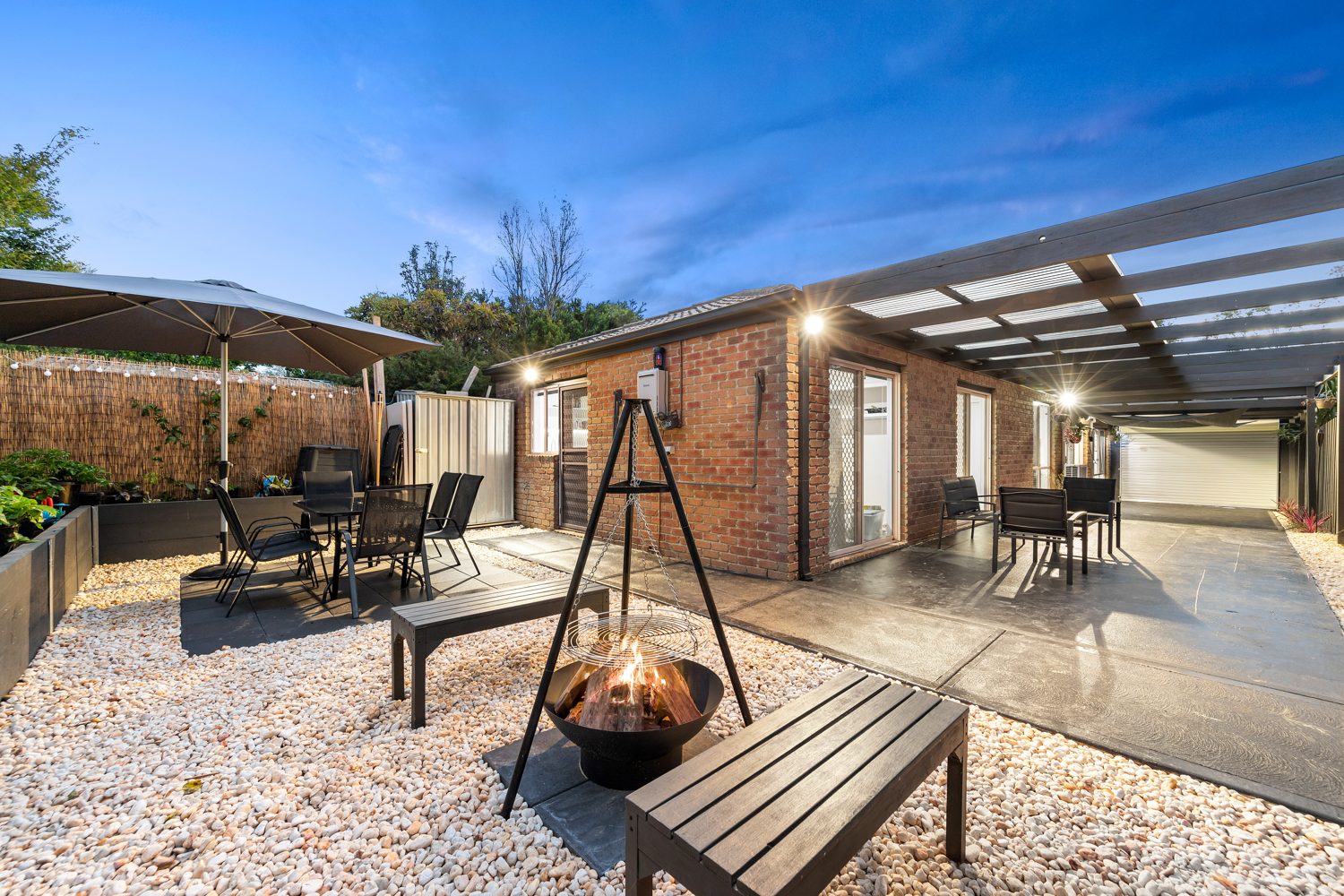 Rear courtyard with firepit at dusk, Berwick