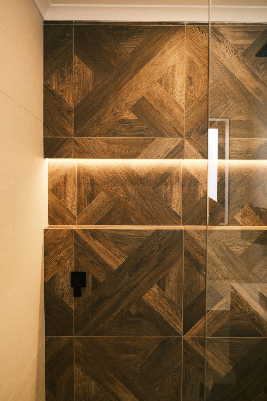 Dark-timber parquet feature wall with LED-lit niche, Berwick ensuite